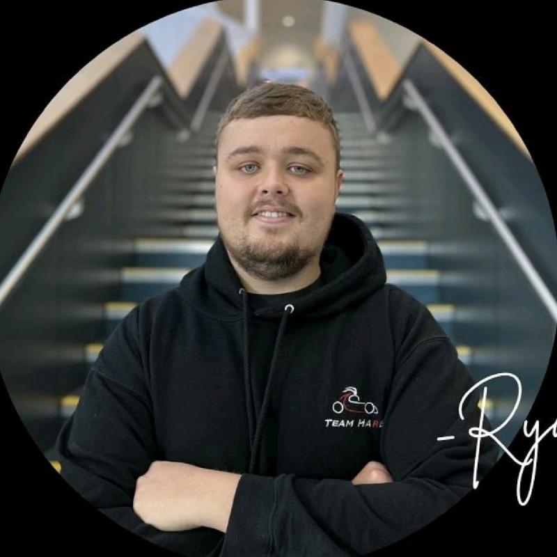 Student wearing black hoodie smiling to the camera