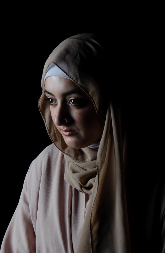 A young muslim girl wearing a cream sari